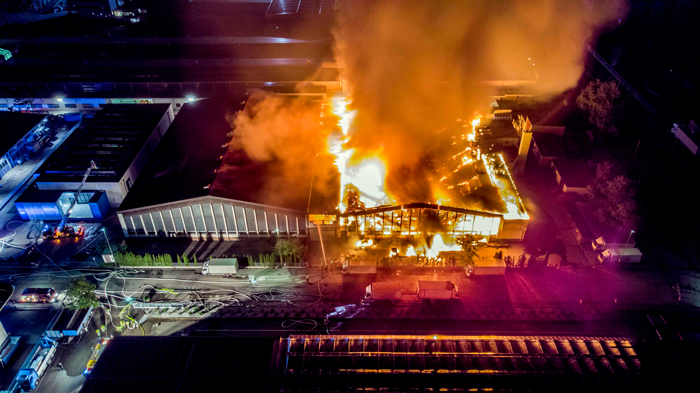 Dramatic image of warehouse fire at night